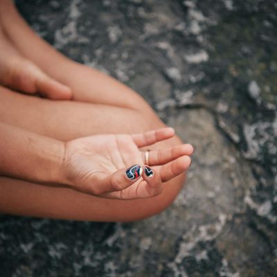 Close-up on hands in a meditative mudra position.